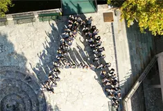 Students viewed from above forming the letter A