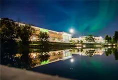 University campus building in the evening underneath the northern lights